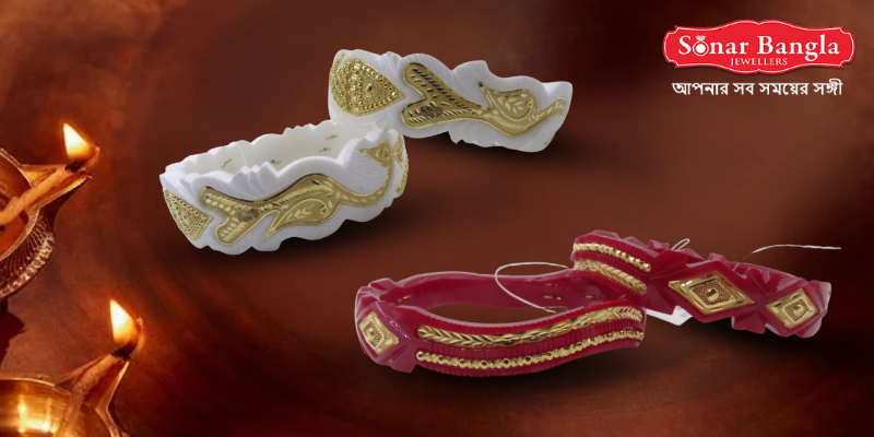 Traditional Bengali white and gold Shankha (conch shell) and red and gold Pola bangles, with two lit clay diyas in the foreground, against a warm, festive brown background.