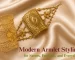 A close-up of a woman wearing a broad, rectangular traditional gold armlet with intricate filigree work by Sonar Bangla Jewellers.