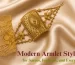 A close-up of a woman wearing a broad, rectangular traditional gold armlet with intricate filigree work by Sonar Bangla Jewellers.